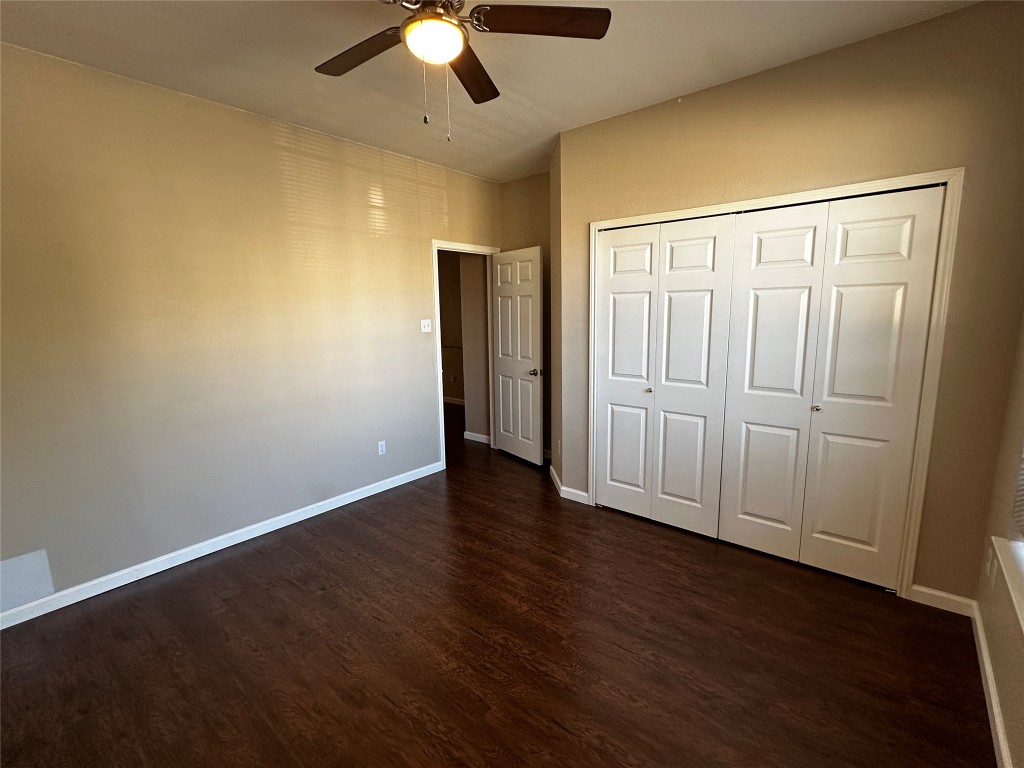 1041 Disraeli Circle Pflugerville, TX 78660 - Photo 26 of 29 an empty room with wooden floor closet and windows