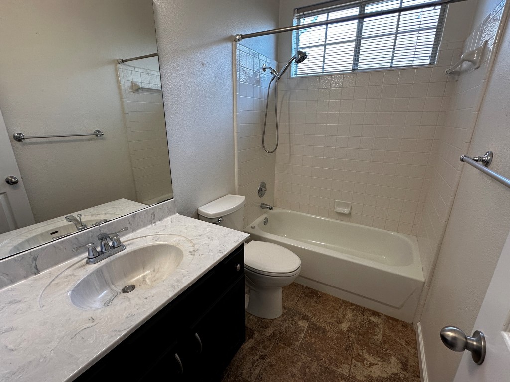 1041 Disraeli Circle Pflugerville, TX 78660 - Photo 27 of 29 a bathroom with a sink a toilet and shower