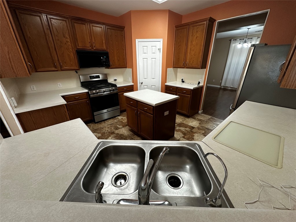 1041 Disraeli Circle Pflugerville, TX 78660 - Photo 10 of 29 a living room with a couch and a flat screen tv
