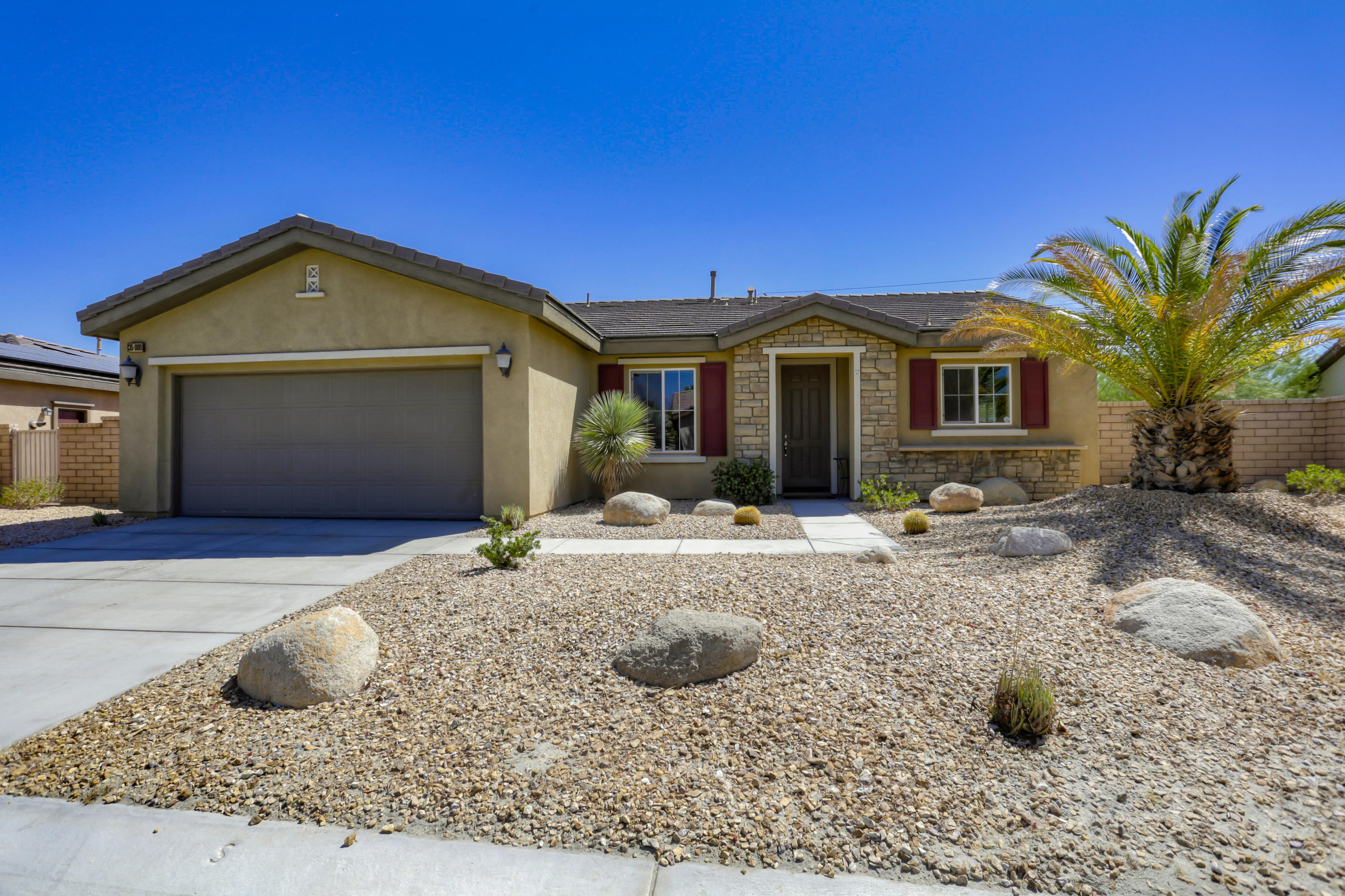 35880 Raphael Drive Palm Desert, CA 92211 - Photo 1 of 28 a front view of a house with yard