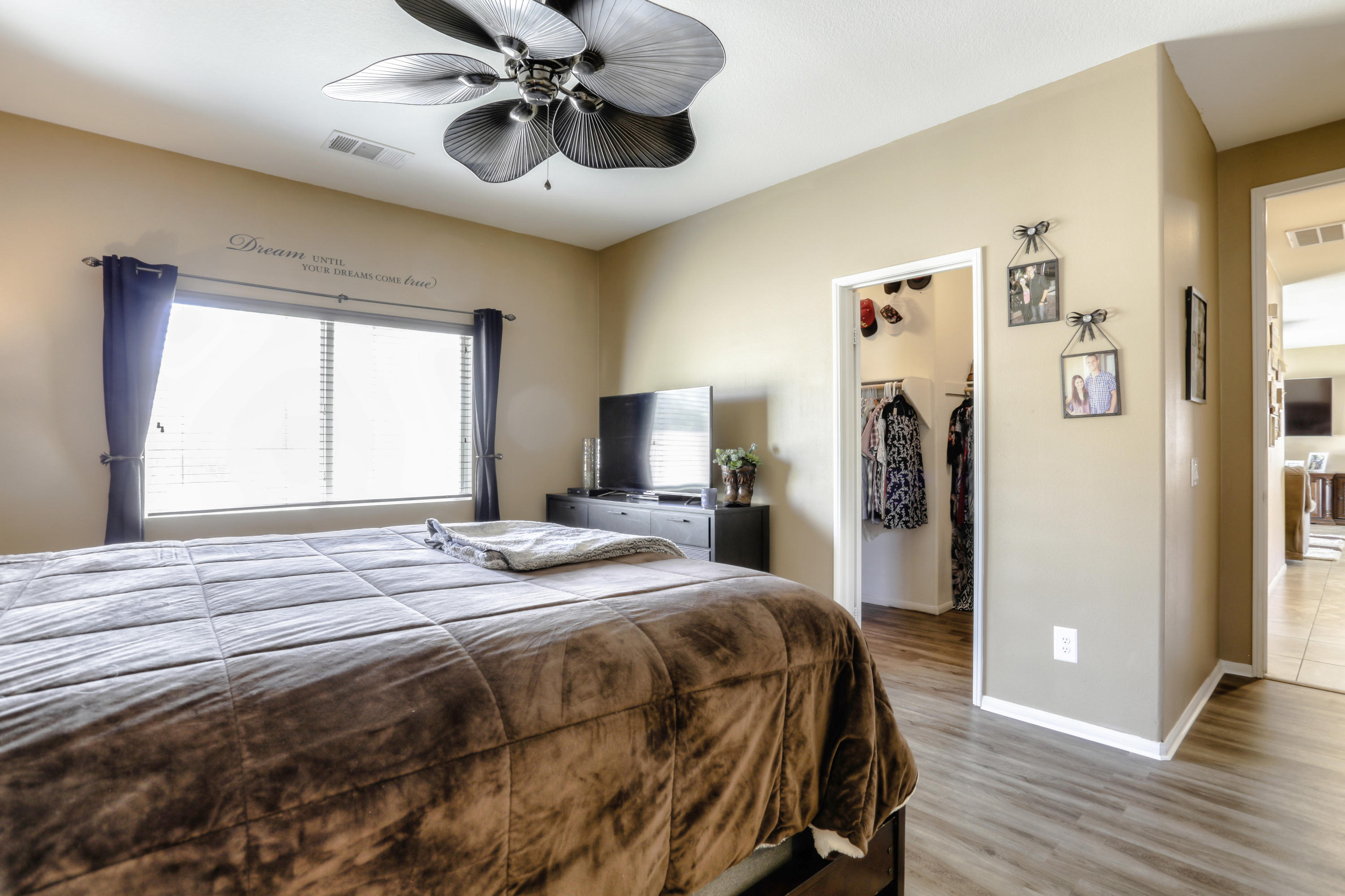 35880 Raphael Drive Palm Desert, CA 92211 - Photo 18 of 28 a bedroom with a bed and wooden floor