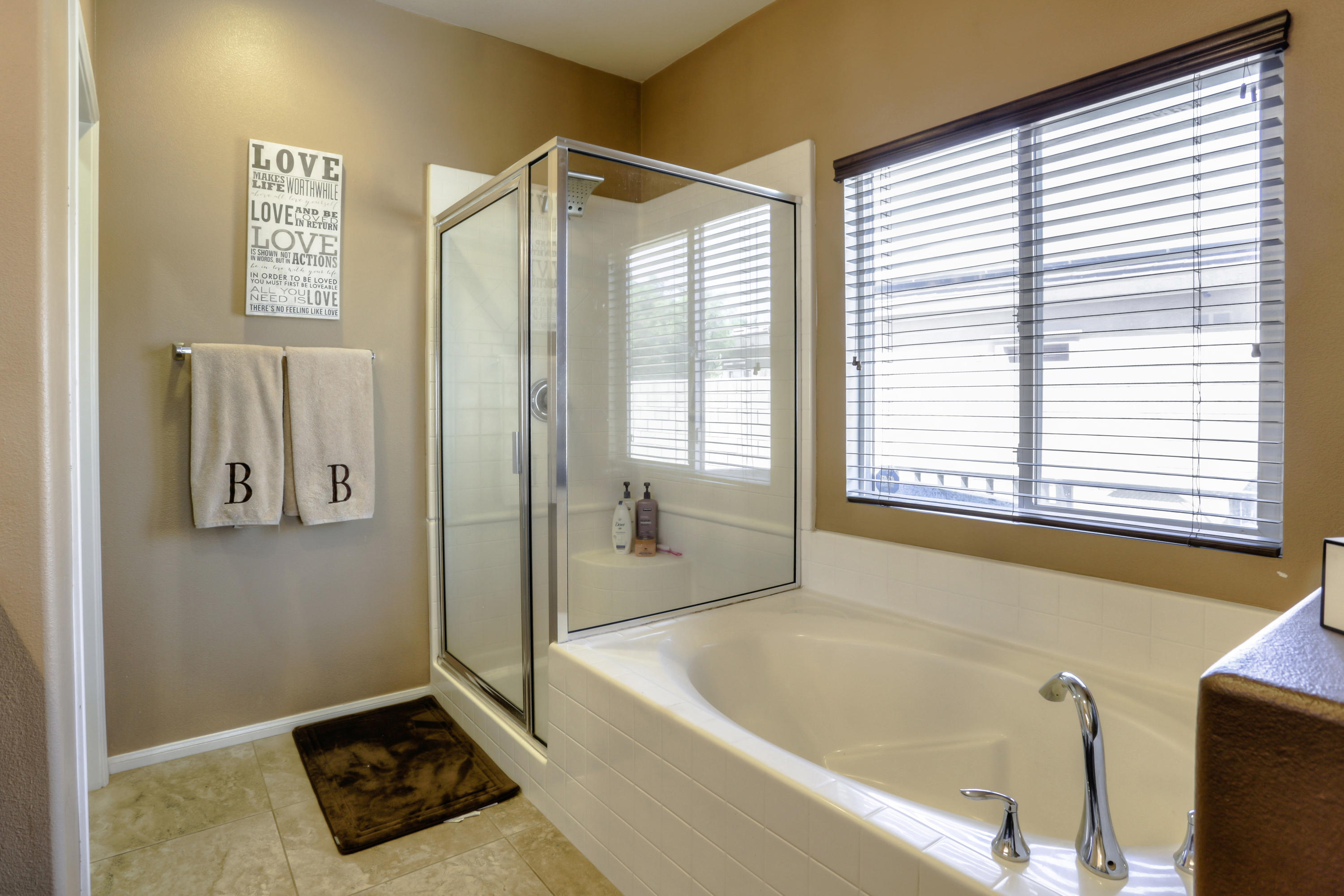 35880 Raphael Drive Palm Desert, CA 92211 - Photo 20 of 28 a bathroom with a bathtub and a shower