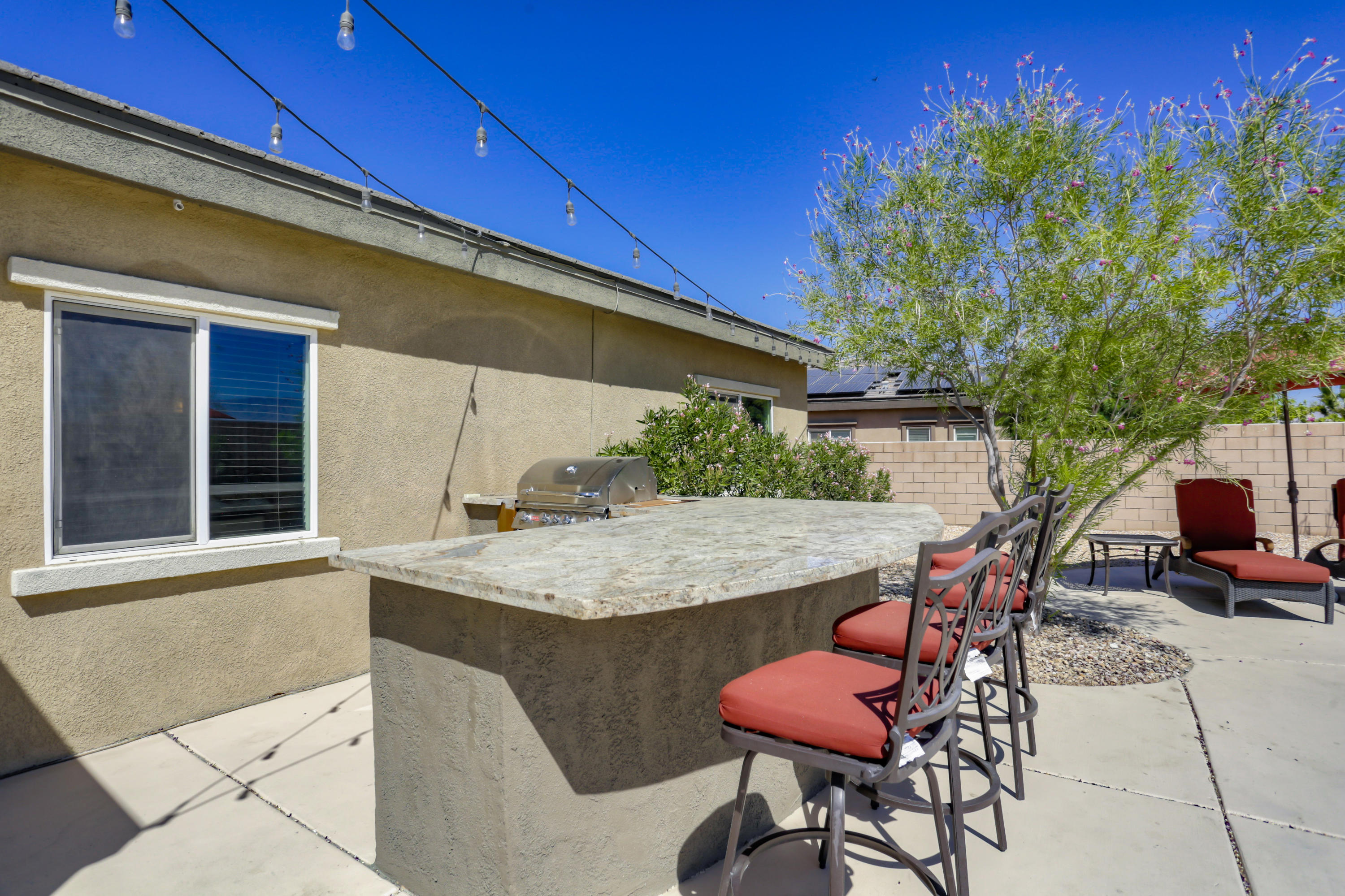 35880 Raphael Drive Palm Desert, CA 92211 - Photo 26 of 28 a patio with a table and chairs and potted plants