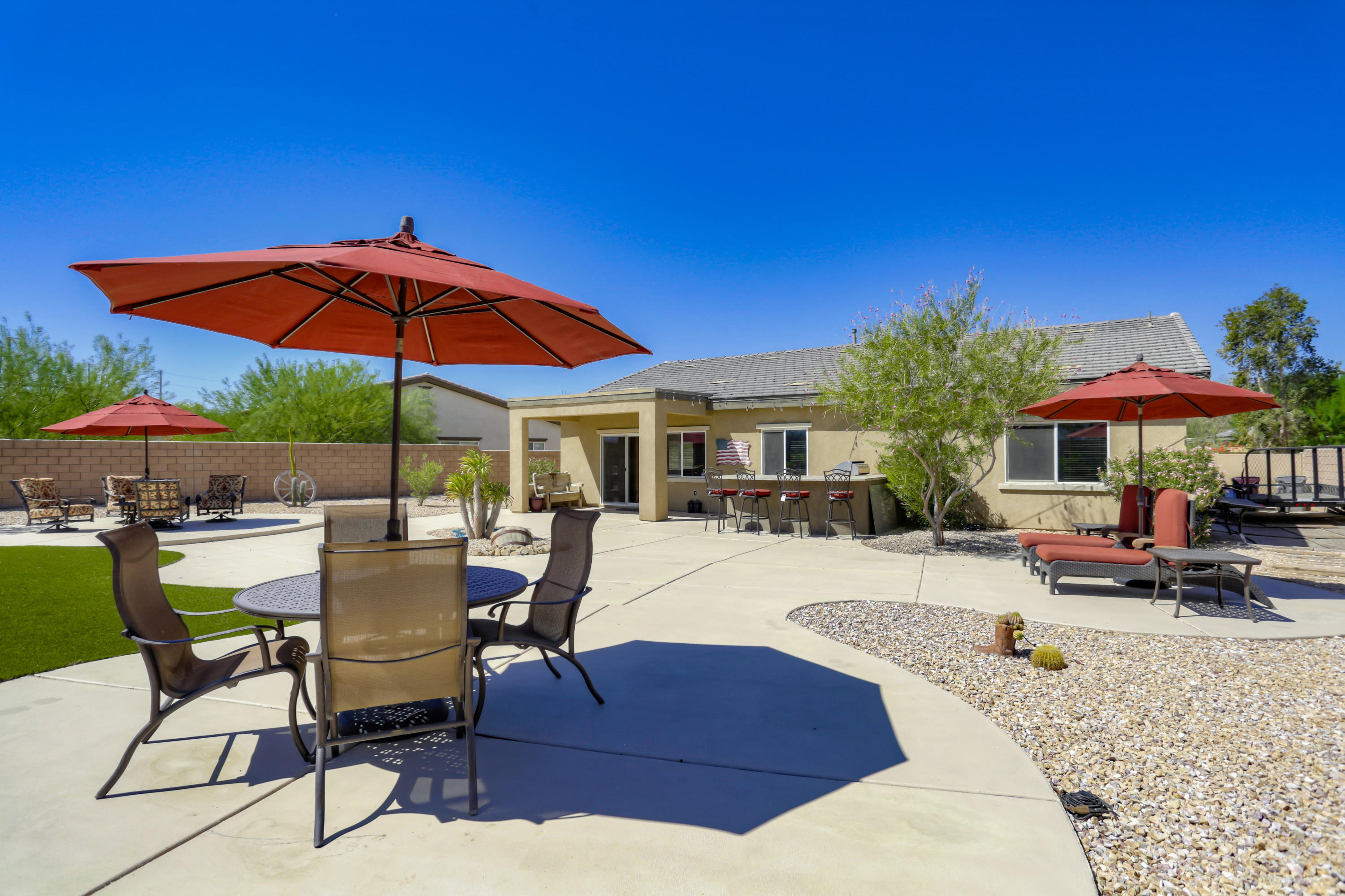 35880 Raphael Drive Palm Desert, CA 92211 - Photo 27 of 28 a view of a swimming pool with a table and chairs under an umbrella