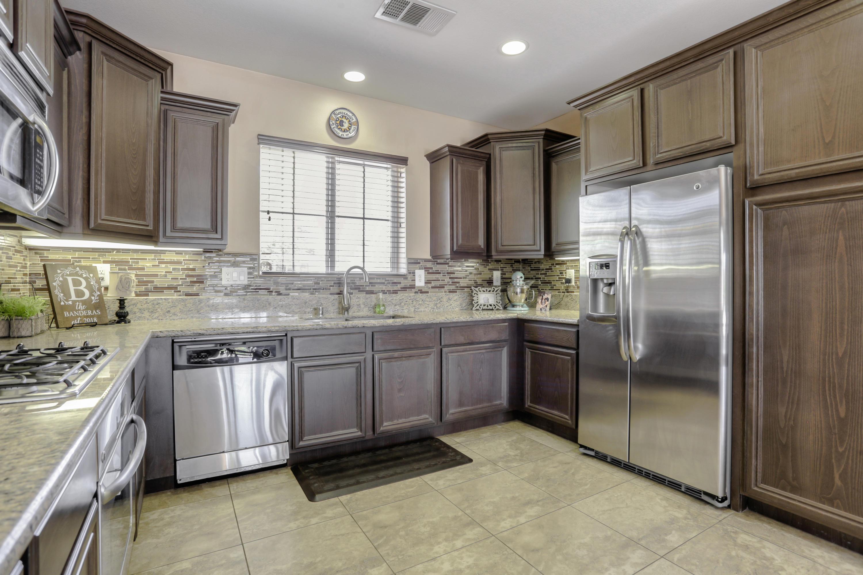 35880 Raphael Drive Palm Desert, CA 92211 - Photo 8 of 28 a kitchen with stainless steel appliances granite countertop a stove a sink and a refrigerator