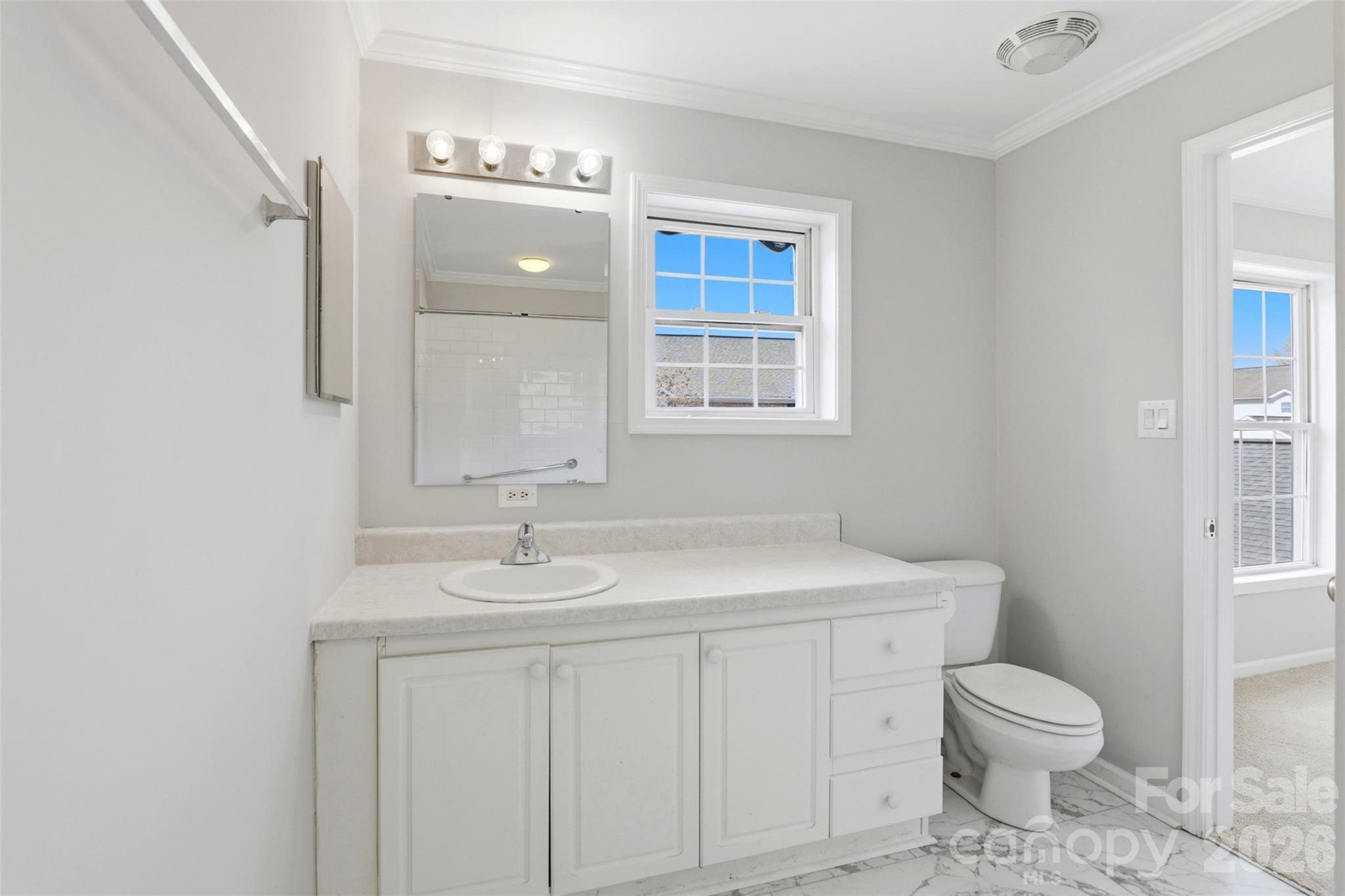 7019 Walnut Ridge Court Charlotte, NC 28273 - Photo 21 of 30 a bathroom with a granite countertop toilet a sink and a mirror