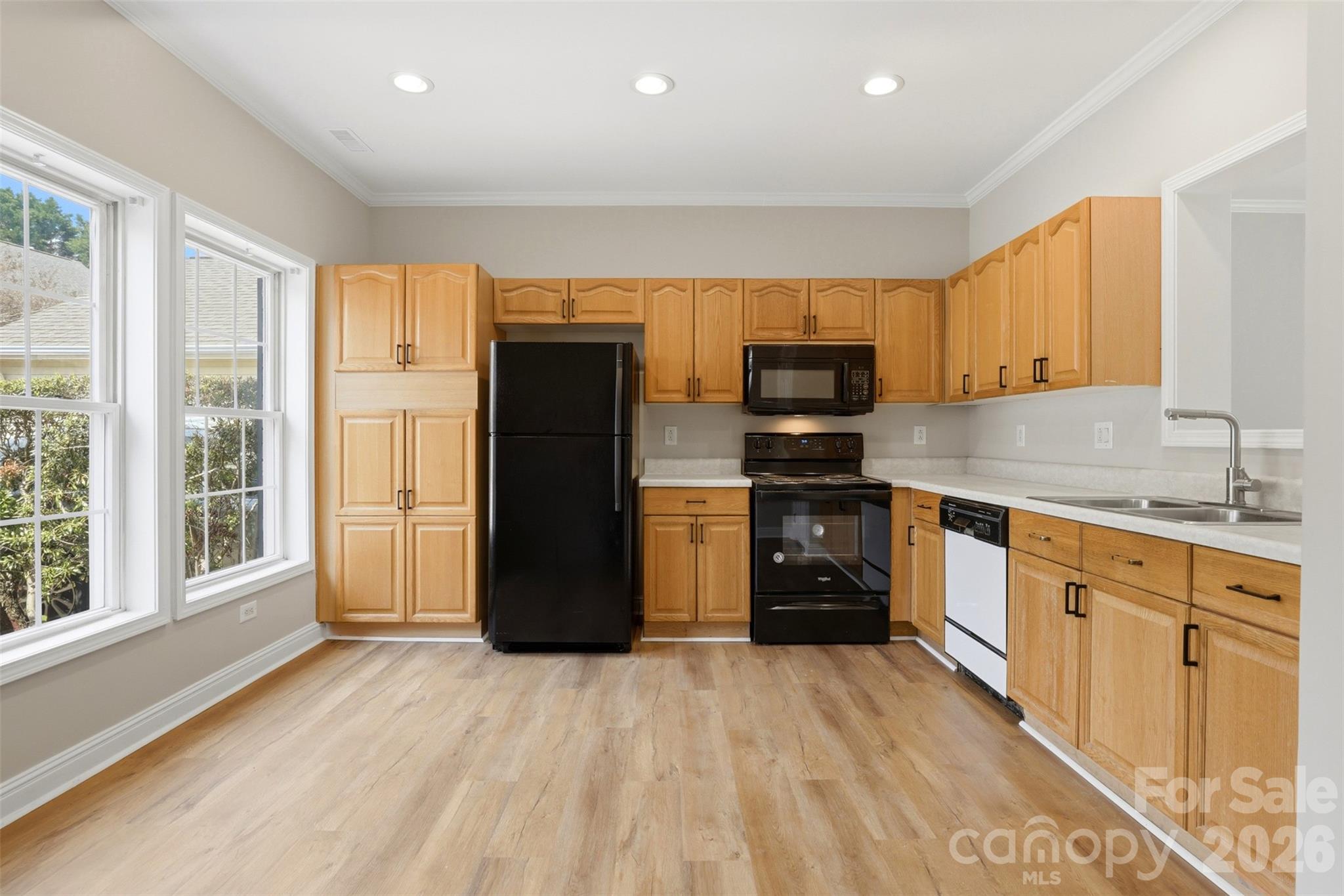 7019 Walnut Ridge Court Charlotte, NC 28273 - Photo 4 of 30 a kitchen with a refrigerator and a sink