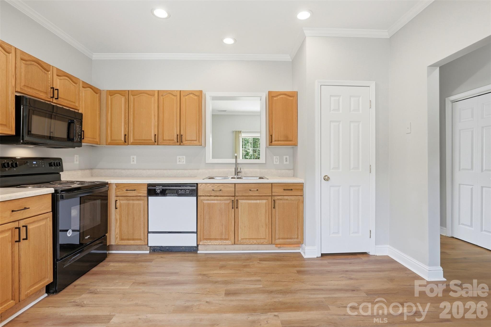7019 Walnut Ridge Court Charlotte, NC 28273 - Photo 5 of 30 a kitchen with granite countertop a stove top oven sink and cabinets