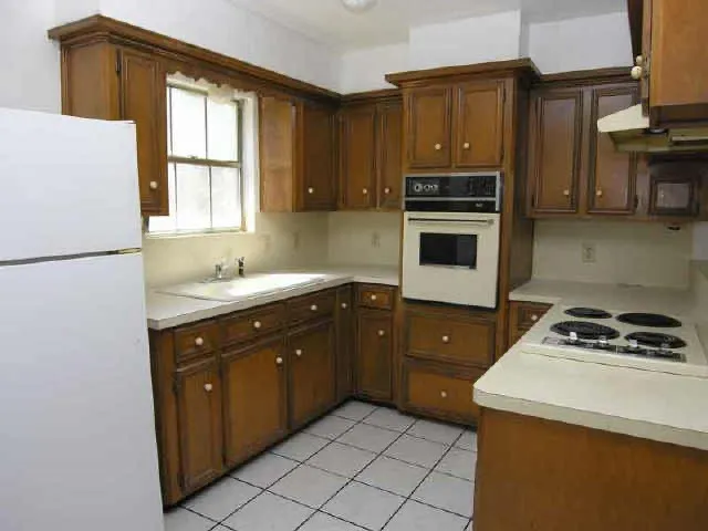 a kitchen with a stove a sink and a refrigerator