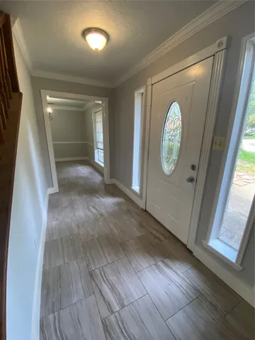 a view of a hallway with wooden floor