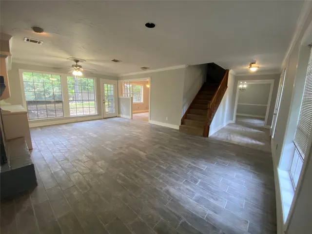 a view of an empty room with a fireplace and a window