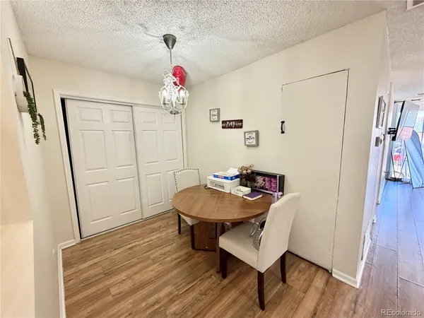 a view of a room with furniture and wooden floor