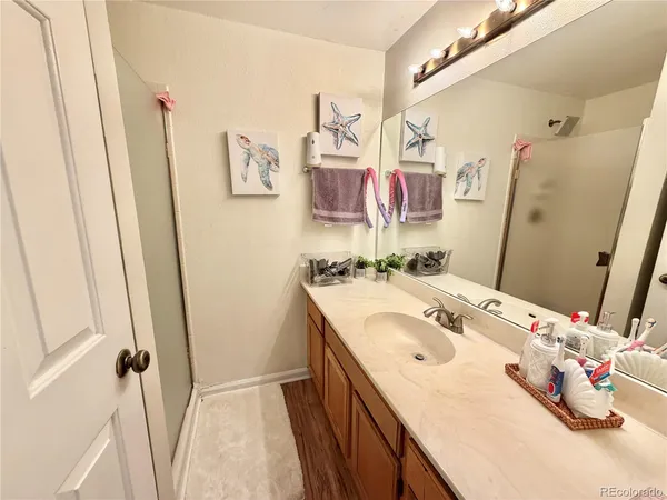 a bathroom with a sink vanity and mirror