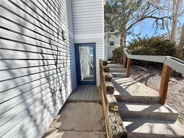 a view of balcony with wooden floor and seating space