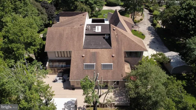 an aerial view of a house with a yard and potted plants