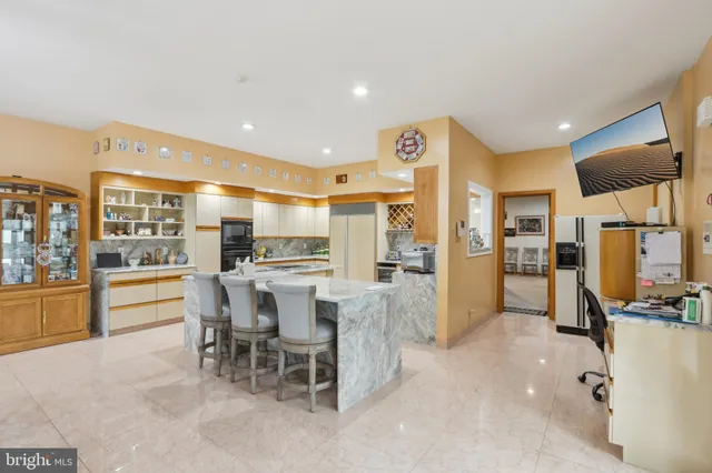 a bathroom with a sink a large mirror and a bathtub