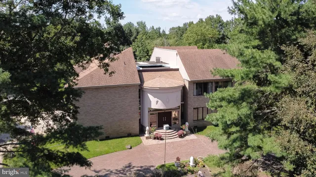 an aerial view of a house with a yard and lake view