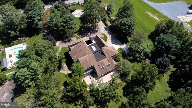 an aerial view of a house with a swimming pool yard and outdoor seating