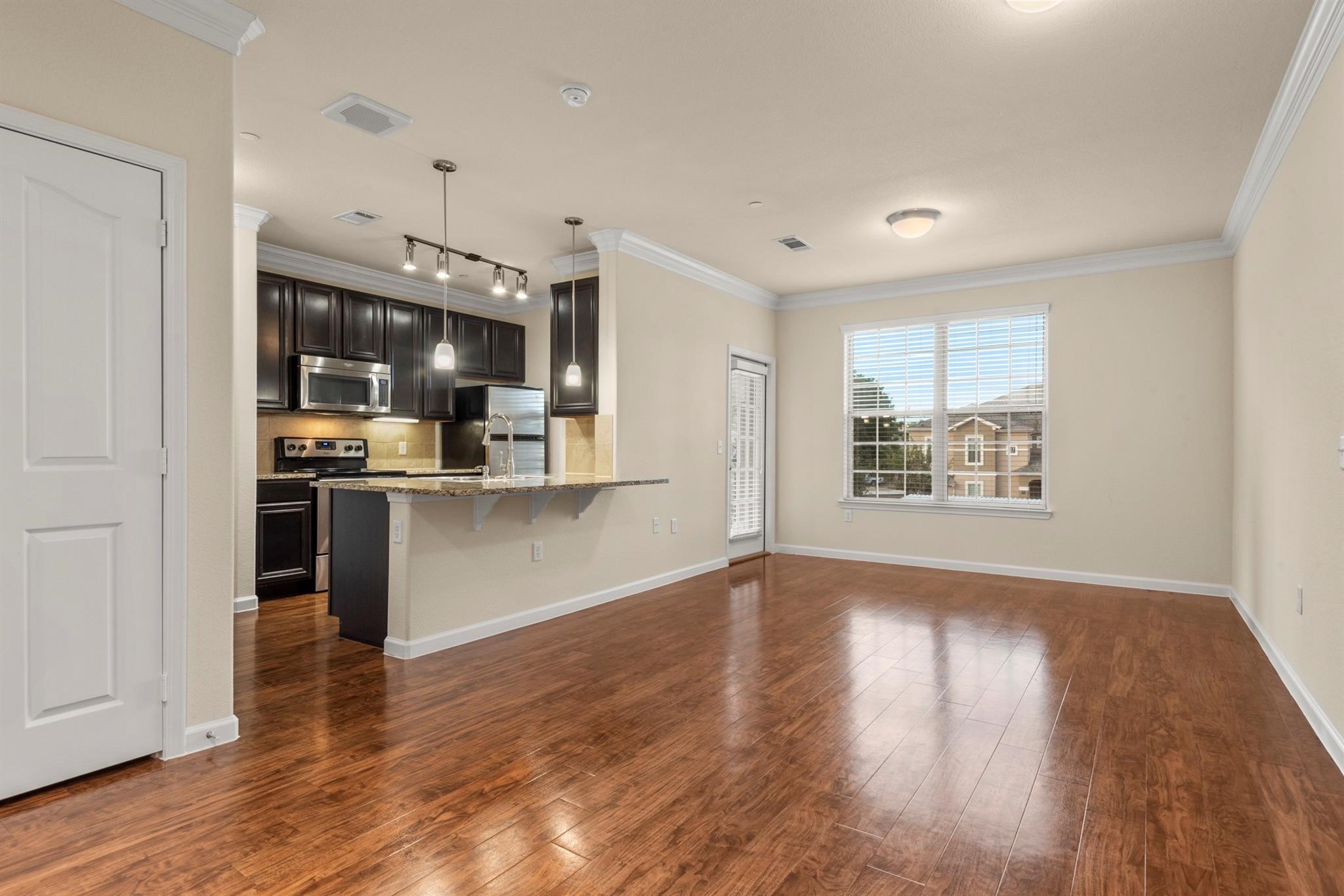 29980 Fm 2978 Road, Unit A7 Magnolia, TX 77354 - Photo 2 of 10 a view of kitchen with cabinets and wooden floor