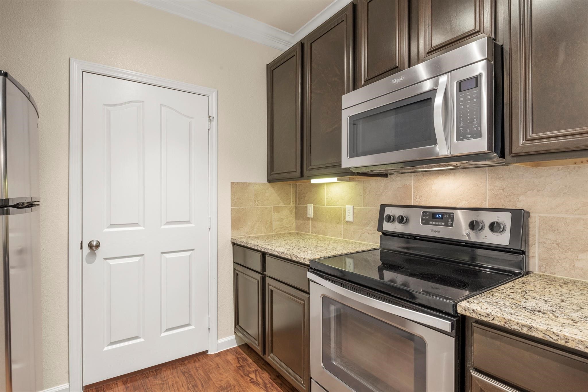 29980 Fm 2978 Road, Unit A7 Magnolia, TX 77354 - Photo 4 of 10 a kitchen with a stove microwave and sink