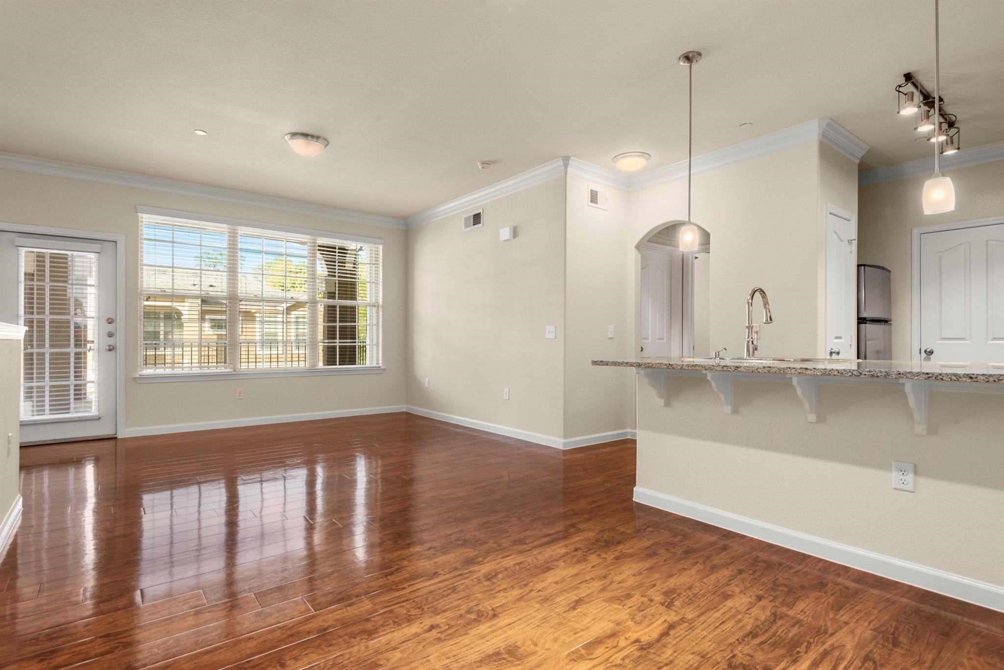 29980 Fm 2978 Road, Unit A7 Magnolia, TX 77354 - Photo 6 of 10 a view of an empty room with a window and wooden floor