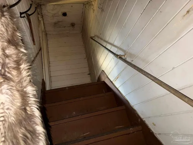 a room with lots of clutter and stainless steel appliances