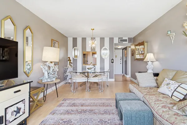 a living room with furniture a rug and a flat screen tv