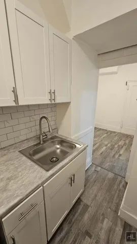 a kitchen with a sink and cabinets