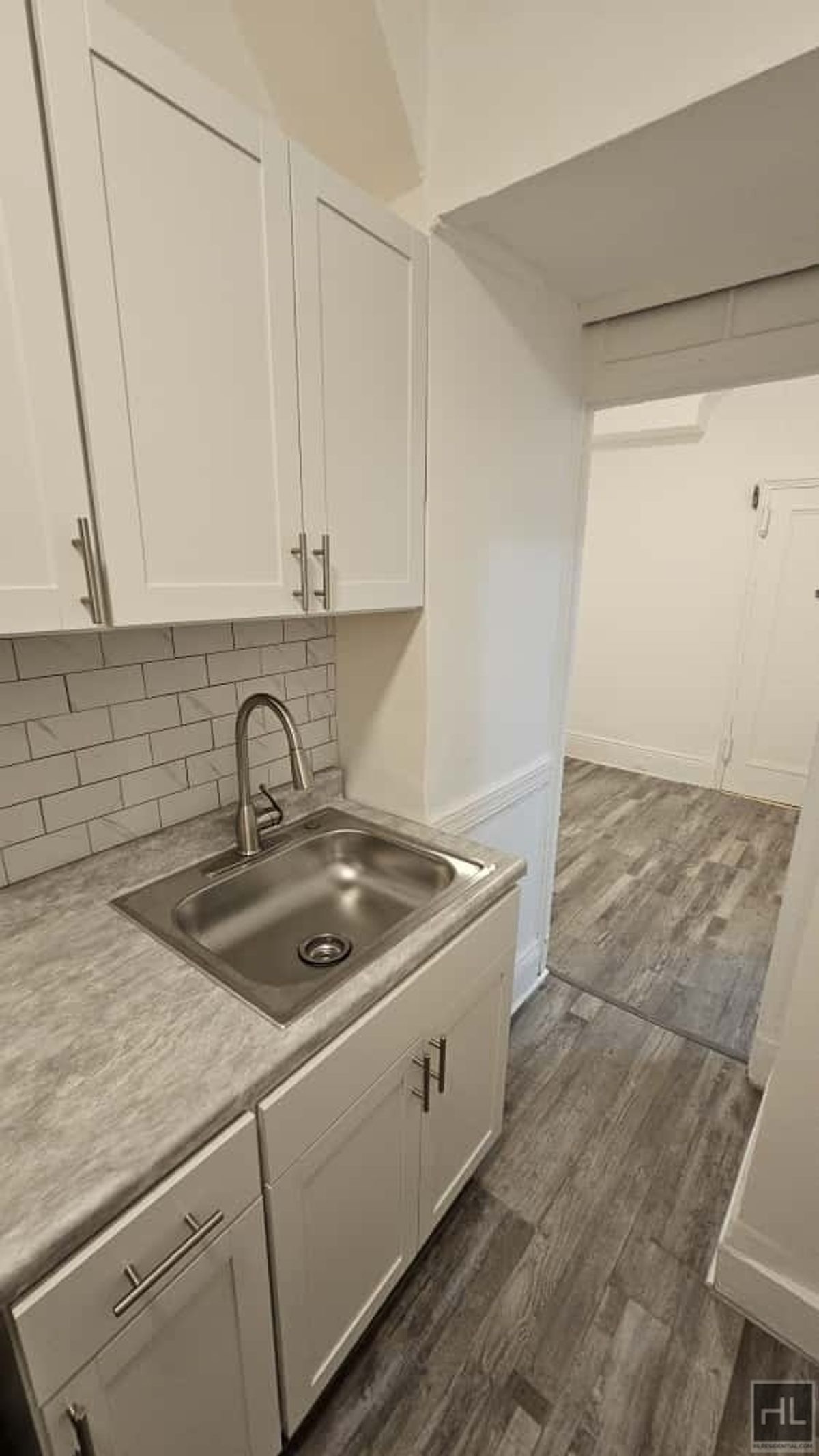 788 Macon Street, Unit 2 Brooklyn, NY 11233 - Photo 12 of 19 a kitchen with a sink and cabinets