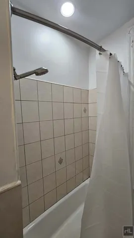 a bathroom with a shower and a bathtub