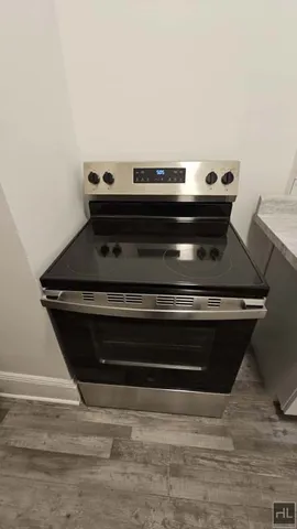 a stove top oven sitting on top of a wooden floor