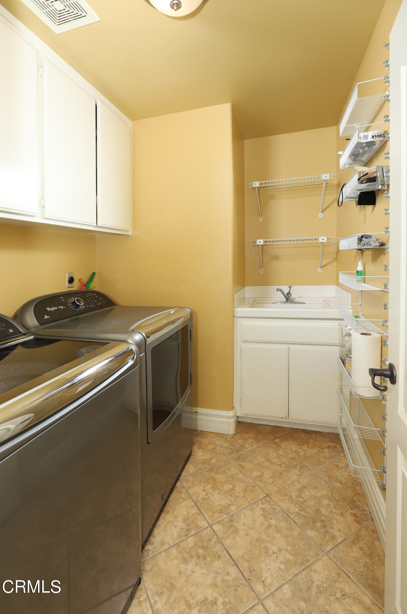 11202 Bentcreek Road Moorpark, CA 93021 - Photo 22 of 51 a utility room with cabinets washer and dryer