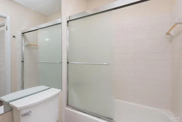 a bathroom with a shower and a toilet