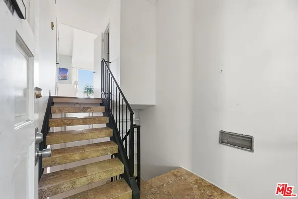 a view of staircase with white walls