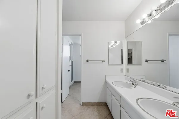 a bathroom with a granite countertop sink mirror and a bathtub