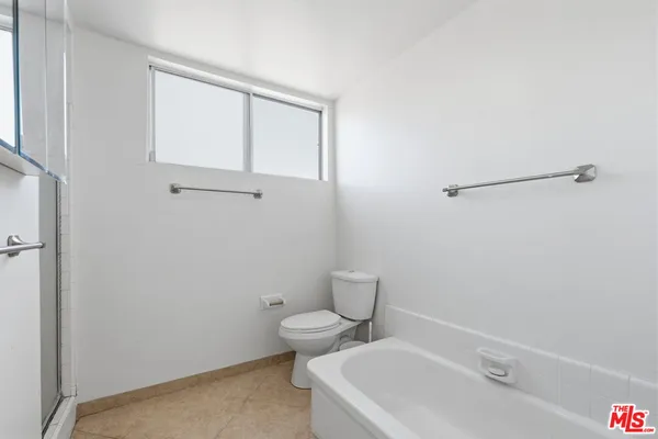 a white toilet sitting next to a bathroom sink