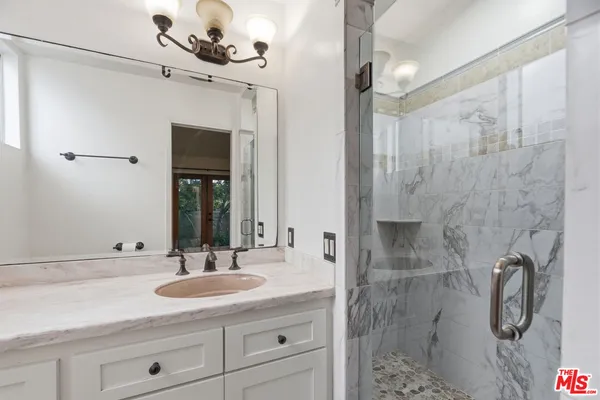 a bathroom with a sink double vanity shower and a mirror
