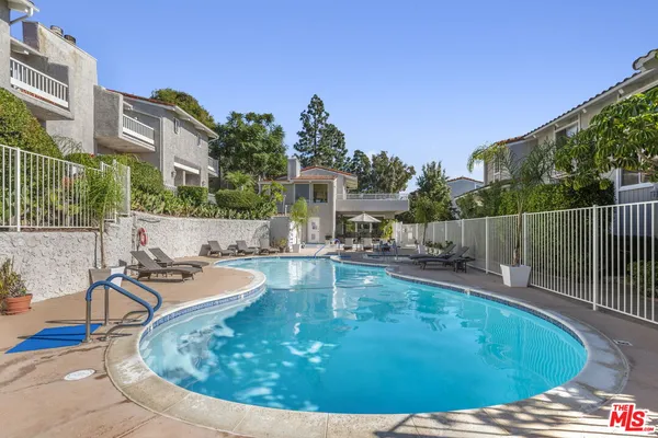 a view of a swimming pool with a patio