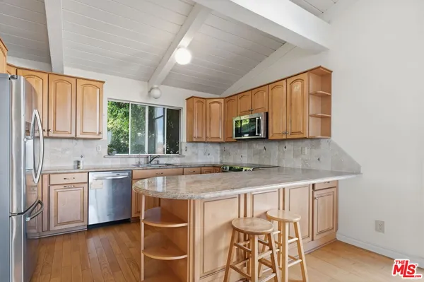 a kitchen with a sink cabinets and window