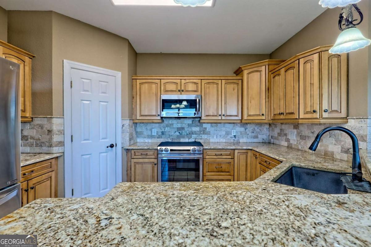 1279 Harris Ridge Road, Unit 24 Young Harris, GA 30582 - Photo 16 of 81 a kitchen with stainless steel appliances granite countertop a sink stove and refrigerator