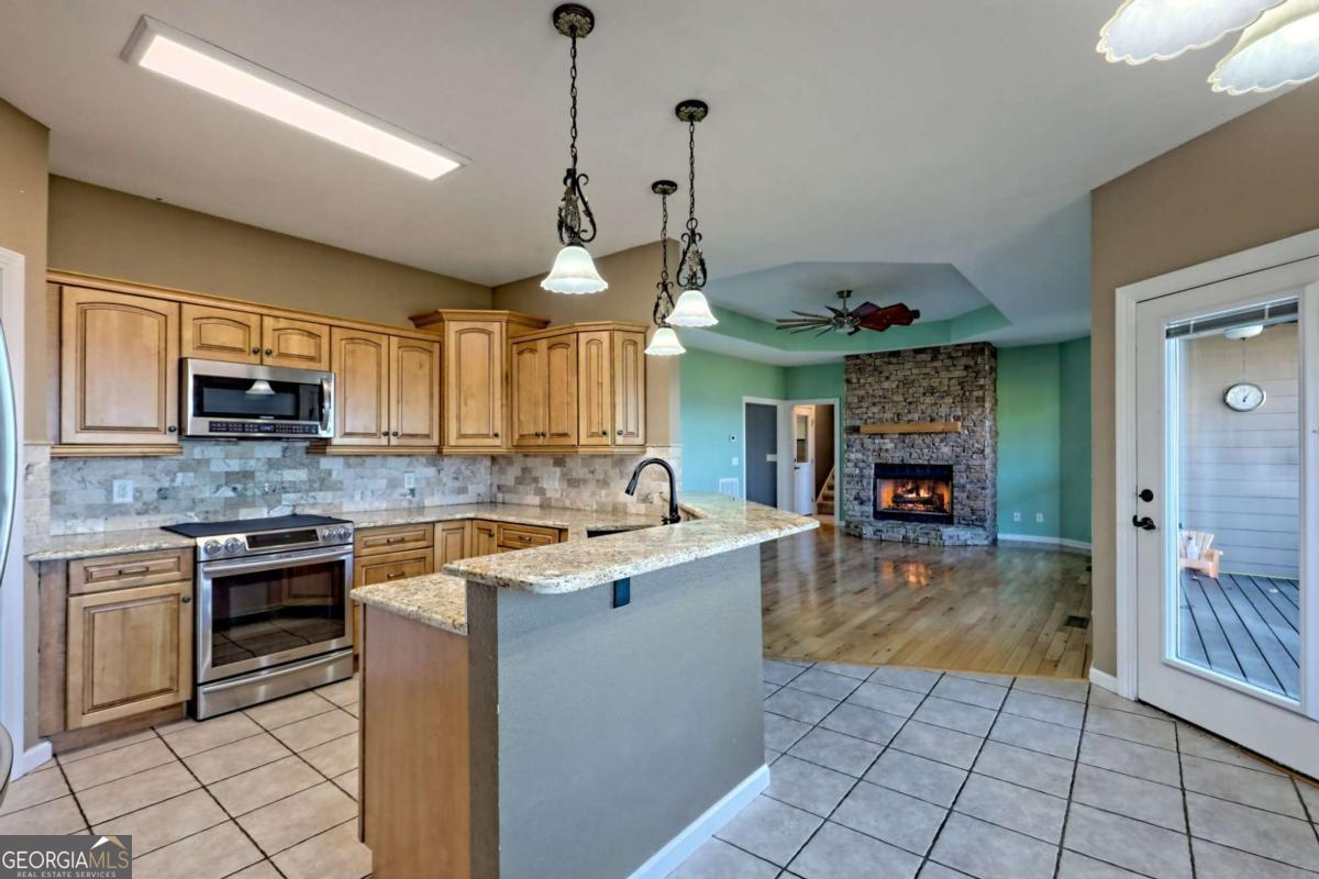 1279 Harris Ridge Road, Unit 24 Young Harris, GA 30582 - Photo 17 of 81 a kitchen with stainless steel appliances granite countertop a sink a stove top oven a counter space and cabinets