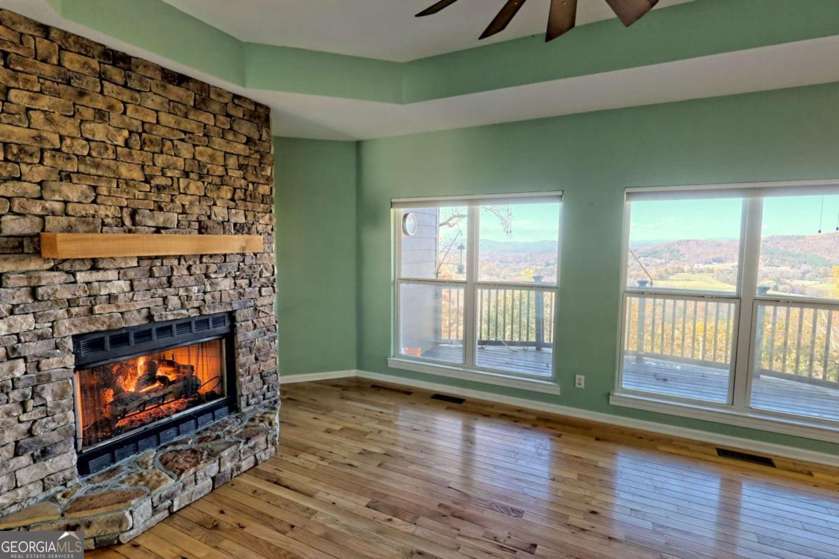 1279 Harris Ridge Road, Unit 24 Young Harris, GA 30582 - Photo 25 of 81 a living room with a fireplace with wooden floor