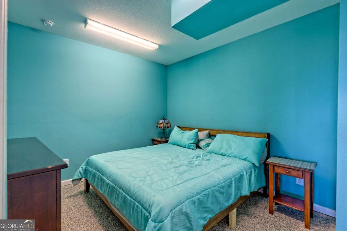 1279 Harris Ridge Road, Unit 24 Young Harris, GA 30582 - Photo 52 of 81 a bedroom with a bed and a chair