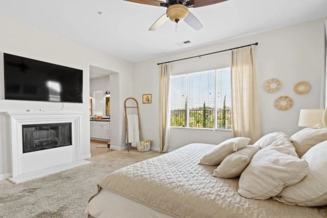 a bathroom with a sink a toilet and shower curtain