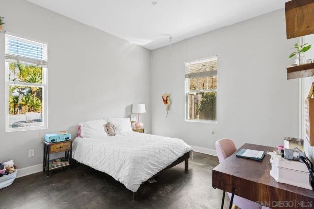 a living room with furniture and a kitchen area