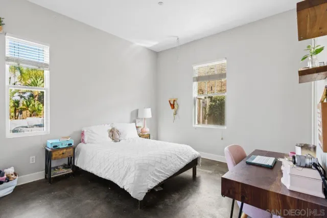 a living room with furniture and a kitchen area