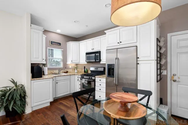 a view of a patio with a table and chairs under an umbrella