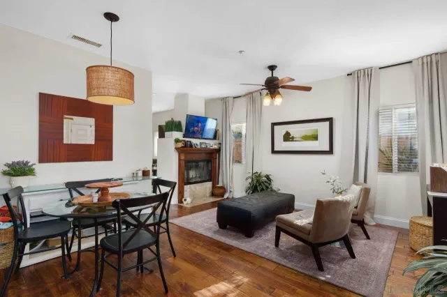 a view of a backyard with a patio table and chairs under an umbrella