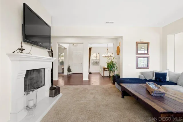 a living room with furniture fireplace and flat screen tv