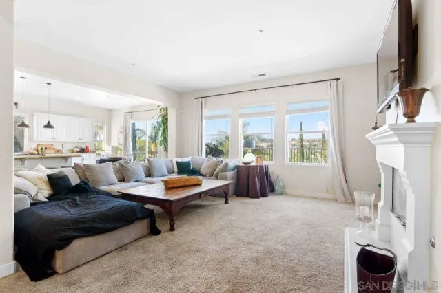 a living room with furniture fireplace and window